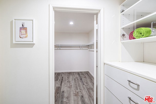 spacious closet with light hardwood / wood-style flooring