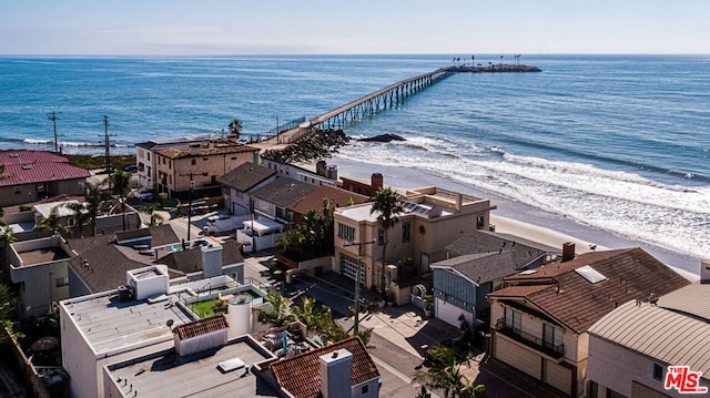 drone / aerial view with a beach view and a water view