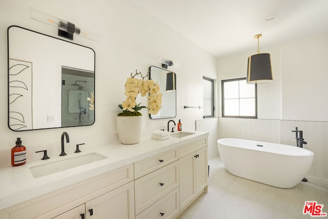 bathroom with tile patterned flooring, a bath, vanity, and tile walls