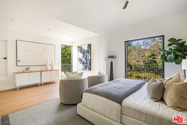 bedroom featuring access to exterior, ceiling fan, and hardwood / wood-style floors