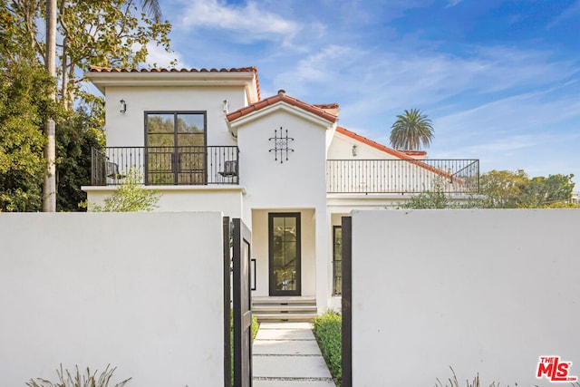 mediterranean / spanish-style home with a balcony