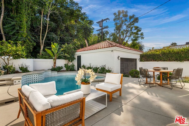 view of pool with an outbuilding and a patio