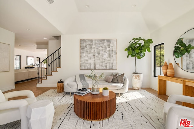 living room featuring light hardwood / wood-style floors and lofted ceiling