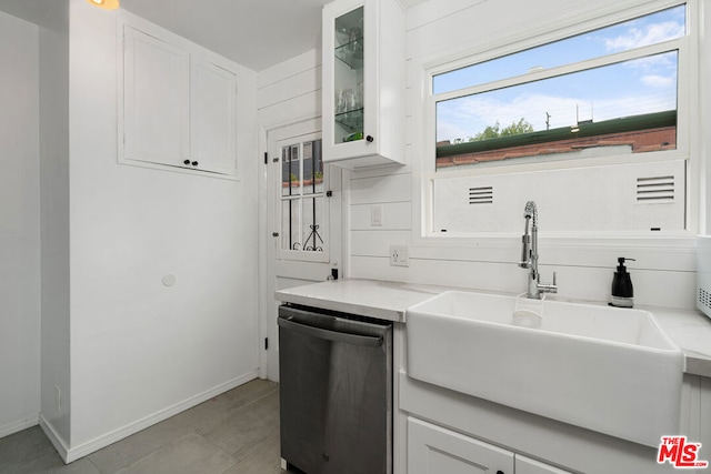 kitchen with white cabinets, stainless steel dishwasher, and sink