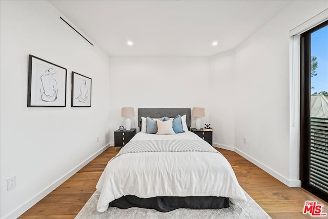 bedroom with wood-type flooring