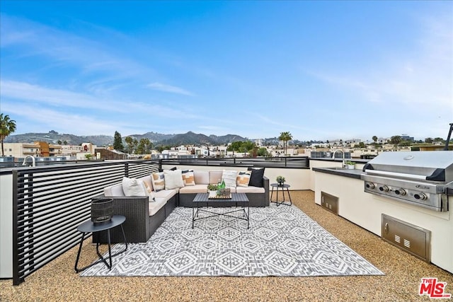 view of patio with a mountain view, an outdoor living space, sink, a balcony, and a grill