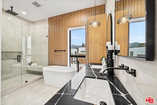 bathroom featuring a water view and plus walk in shower