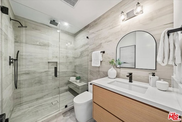 bathroom featuring vanity, an enclosed shower, and toilet