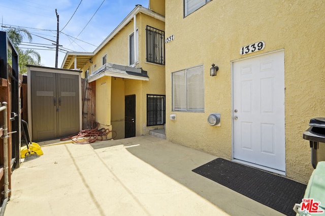 view of exterior entry featuring a patio area