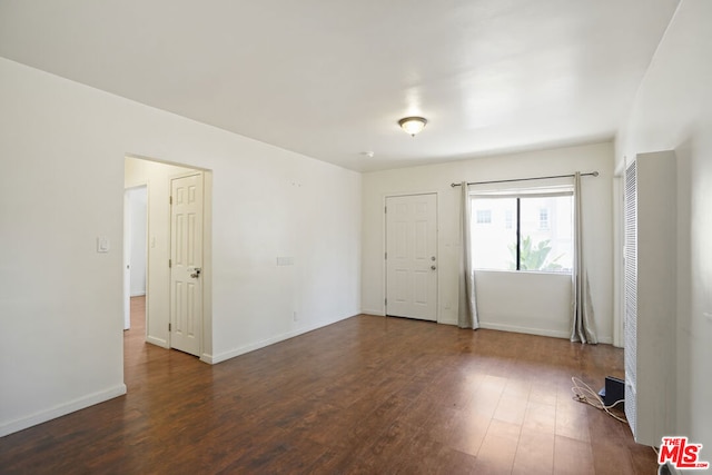 unfurnished room featuring dark hardwood / wood-style flooring