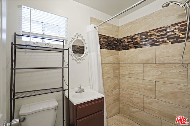 bathroom with vanity, toilet, and walk in shower