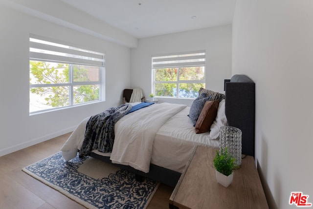 bedroom with hardwood / wood-style floors