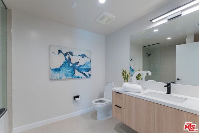 bathroom featuring toilet, a shower, vanity, and tile patterned floors