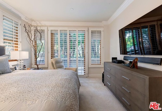 bedroom with crown molding and light carpet