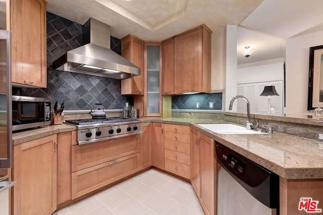 kitchen featuring sink, wall chimney exhaust hood, light tile patterned floors, appliances with stainless steel finishes, and tasteful backsplash