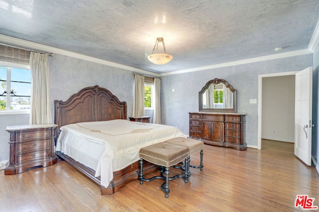 bedroom featuring ornamental molding and light wood-type flooring