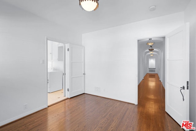 spare room with dark wood-type flooring