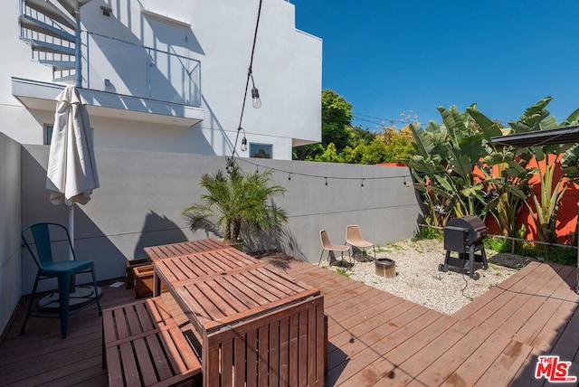 wooden terrace with a grill