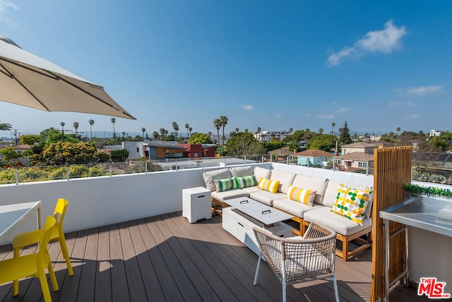 wooden deck with an outdoor living space