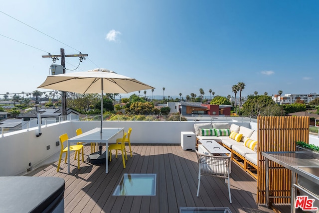 wooden terrace featuring outdoor lounge area