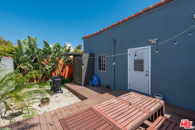 wooden terrace featuring grilling area