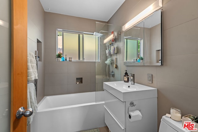 full bathroom featuring vanity, toilet, and tiled shower / bath combo