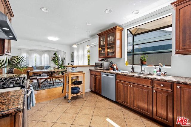 kitchen with sink, hanging light fixtures, ventilation hood, light tile patterned floors, and appliances with stainless steel finishes