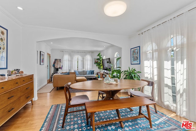 dining room featuring crown molding and light wood-type flooring