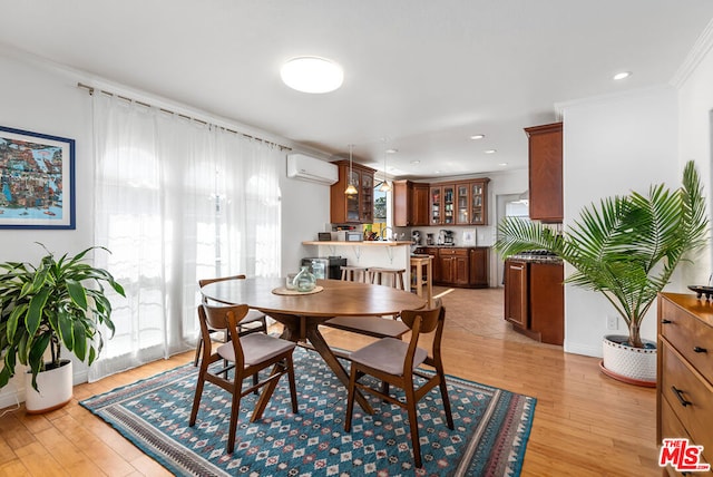 dining area featuring a wall unit AC, plenty of natural light, and light wood-type flooring