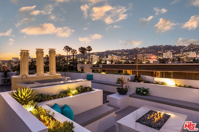 patio terrace at dusk with a fire pit