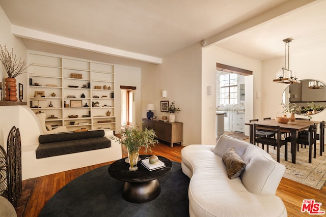 living room featuring hardwood / wood-style flooring and a notable chandelier