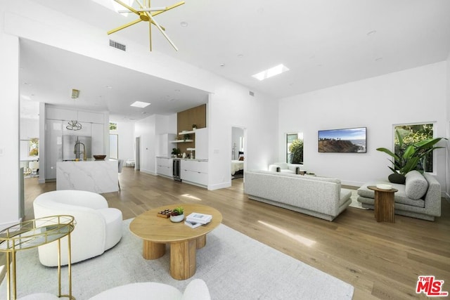 living room featuring a notable chandelier and light hardwood / wood-style floors