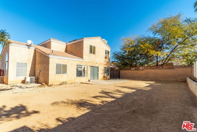 rear view of house featuring central air condition unit