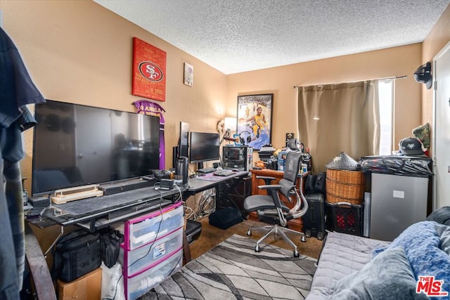 office space with a textured ceiling and carpet floors