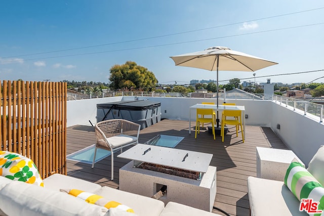 view of dock with an outdoor living space with a fire pit