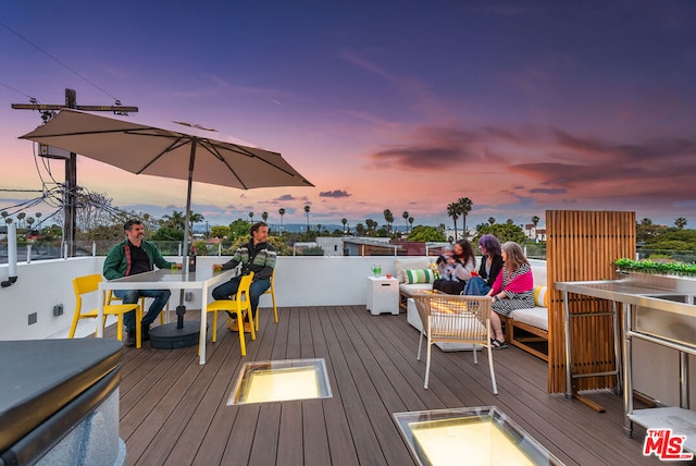 deck at dusk with an outdoor fire pit