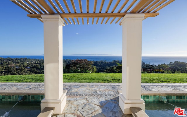 view of patio / terrace with a pergola and a water view