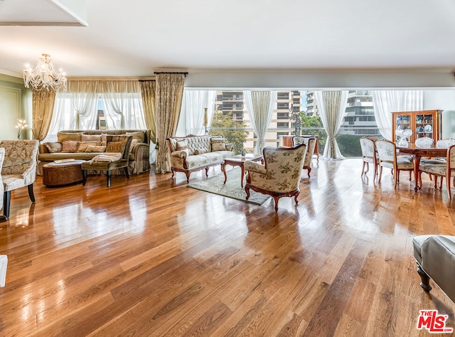 living room with light hardwood / wood-style flooring and an inviting chandelier