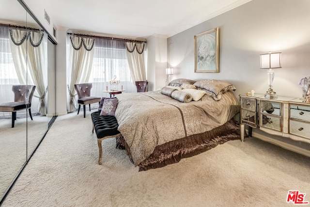 bedroom with light carpet, a closet, and ornamental molding