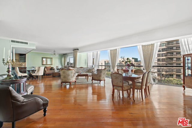 dining area featuring an inviting chandelier and light hardwood / wood-style flooring