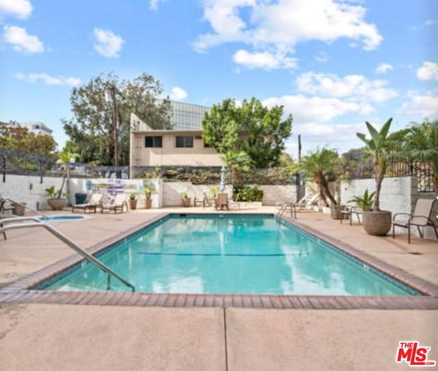 view of swimming pool featuring a patio