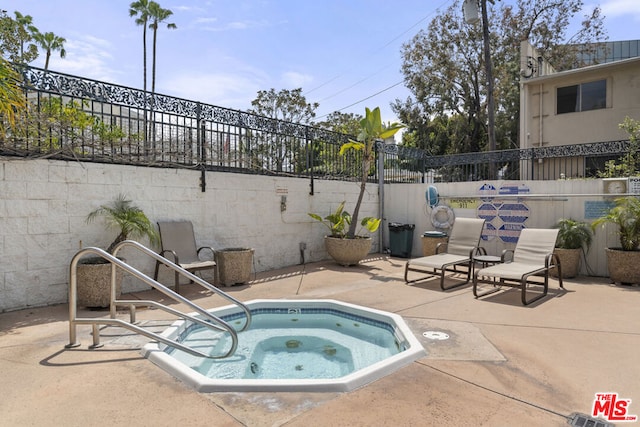 view of pool with a patio area and a community hot tub