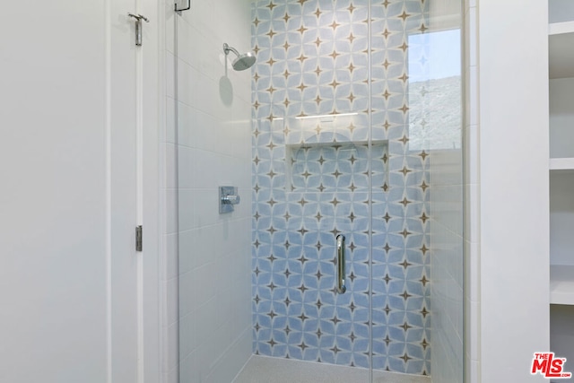 bathroom with a shower with door