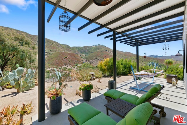 view of patio / terrace featuring outdoor lounge area, a mountain view, and a pergola