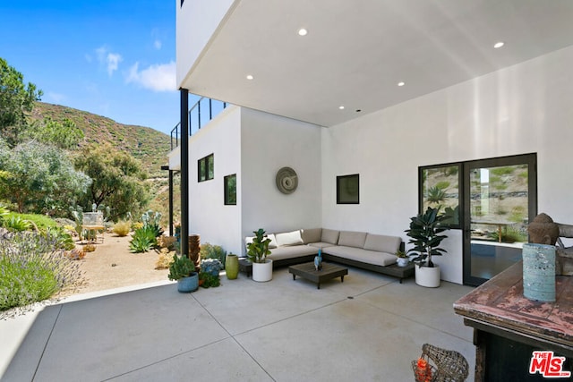 view of patio featuring outdoor lounge area and a mountain view