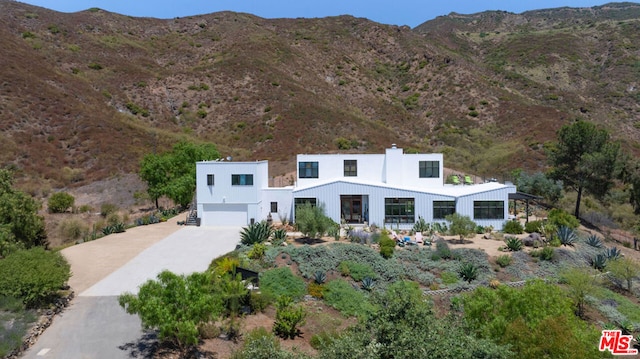 view of front of property with a mountain view and a garage