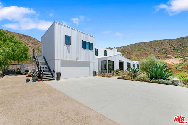 modern home featuring a mountain view and a garage