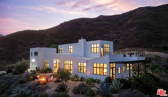 back house at dusk featuring a mountain view