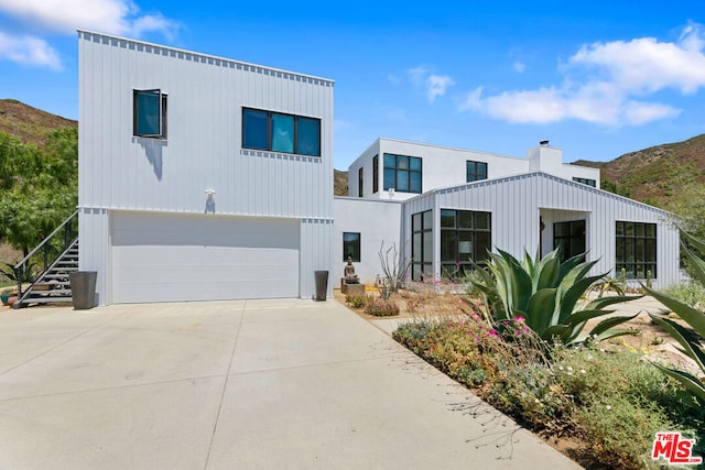 view of front facade with a mountain view and a garage