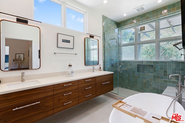 bathroom featuring plus walk in shower and vanity